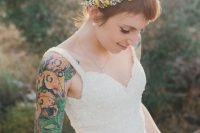 a beautiful A-line wedding dress with an embellished bodice and straps instead of sleeves to show off the bridal tattoos on the shoulders and arms