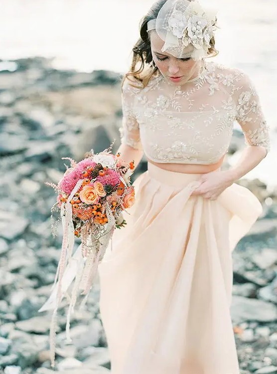 a blush plain pleated skirt and a lace applique crop top with an illusion neckline and half sleeves for a sophisticated wedding