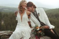 a boho lace A-line wedding dress with a plunging neckline and spaghetti straps for a boho bride