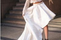a bold modern wedding separate with a lace crop top with long sleeves and a high neckline, a plain high low skirt with a train and black shoes