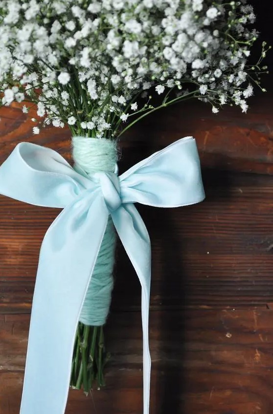 a delicate wedding bouquet of baby's breath, aqua yarn and an aqua bow of silk ribbon for a bride or a bridesmaid