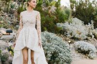 a dreamy lace applique high low wedding dress with a bodice with long sleeves and a high neckline plus a high low skirt with a long train and lace shoes