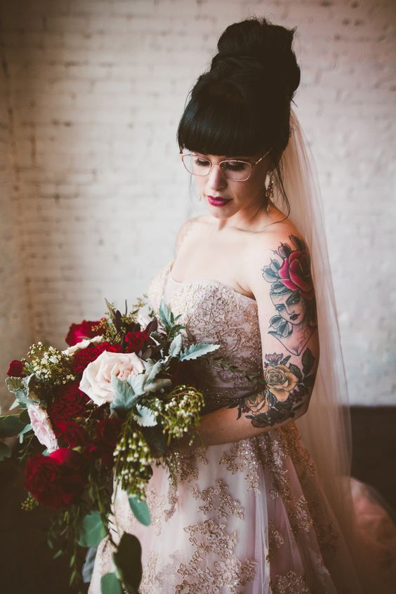 a fabulous pink strapless wedding ballgown with lace appliques and beautiful colorful tattoos on the shoulder and arm