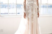 a feminine floral lace applique wedding dress with long sleeves and a plunging neckline
