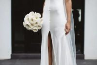 a fresh take on a classic slip dress, a white silk slip gown with a deep V-neckline and a front slit