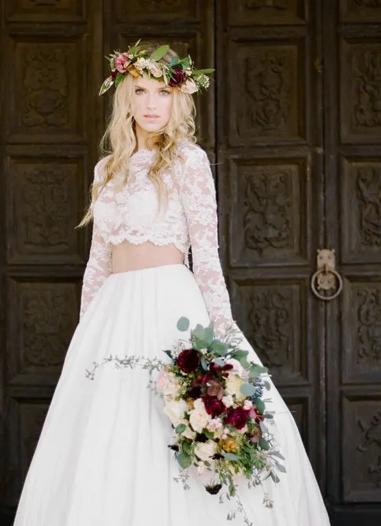 a full plain skirt and a lace crop top with long sleeves and a scallop edge plus a bold contrasting floral crown for a fall wedding