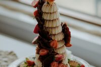 a gorgeous kransenkake decorated with chocolate, strawberries and fresh blooms is a perfect idea for an Icelandic wedding