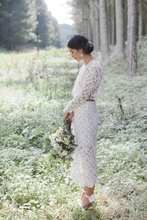 a gorgeous lace bridal separate with a crop top with long sleeves and a high neckline plus a pencil skirt and white shoes