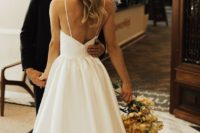 a gorgeous plain wedding ballgown with spaghetti straps, an open back and a sweeping train is very refined