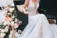 a gorgeous lace sheath wedding dress with thick straps, a plunging neckline and a train