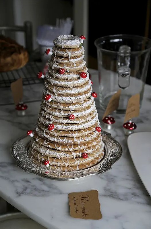 a kransekake with little edible mushrooms is a fun idea for any woodland wedding and a great alternative to a usual cake