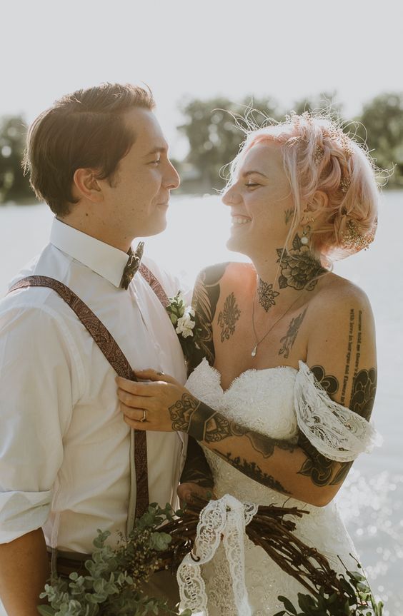 a cute off the should wedding dress is perfect for a tattooed bride