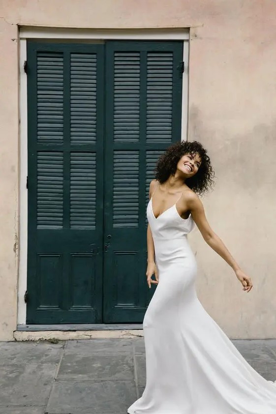 a light slip wedding dress with a highlighted waistline and a train is classics for summer
