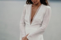 a minimalist wedding dress with a plunging neckline and bell sleeves for a touch of boho