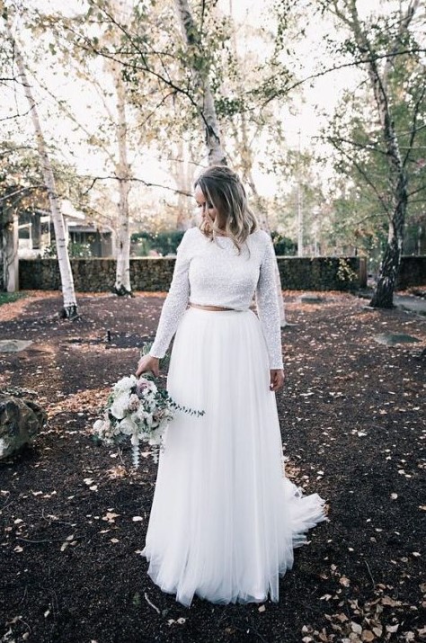a modern and bold bridal separate with a white sequin crop top and long sleeves and a pleated white tulle maxi skirt