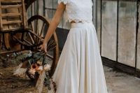 a modern and casual wedding separate with a lace crop top with short sleeves and a high neckline, a pleated skirt with a train