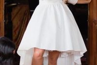 a modern and chic plain high low wedding dress with short sleeves and a high neckline plus shiny booties for a glam look