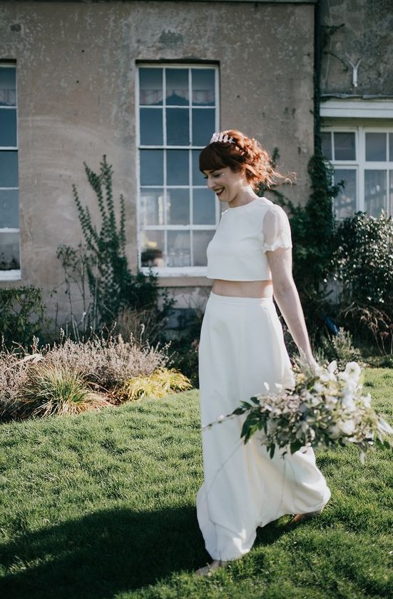 a modern bridal separate with a plain crop with with sheer sleeves and a plain A-line skirt