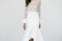 a modern mermaid wedding dress with a lace bodice with long bell sleeves, a high neckline, a plain mermaid ruffle high low skirt and lace up shoes