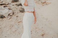 a modern yet romantic bridal separate of a lace crop top with short sleeves and a high neckline and a matching lace mermaid skirt