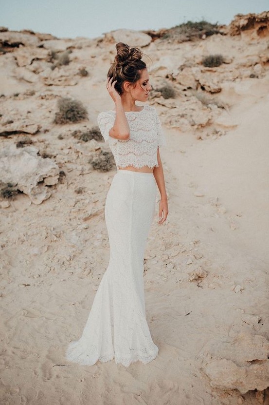 a modern yet romantic bridal separate of a lace crop top with short sleeves and a high neckline and a matching lace mermaid skirt