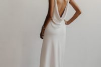 a plain slip wedding dress with a cowl open back and a small train for a minimalist bride