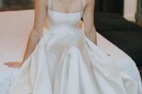a retro-inspired silk A-line wedding dress with thick straps and a square neckline is a refined and beautiful idea for a wedding