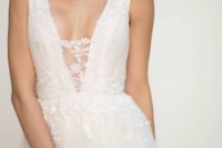 a romantic floral applique wedding dress with an illusion plunging neckline for a romantic bride