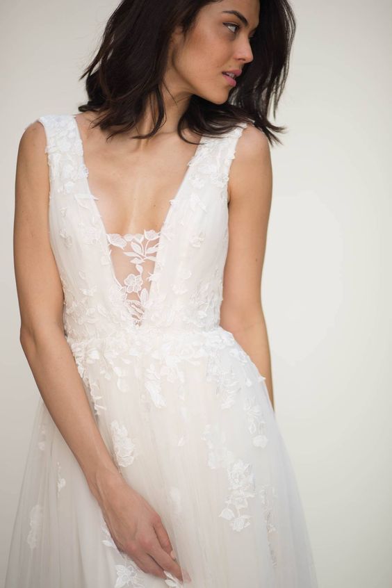 a romantic floral applique wedding dress with an illusion plunging neckline for a romantic bride