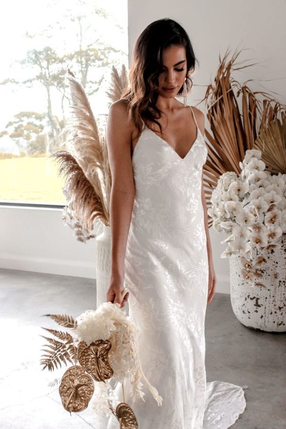 a romantic silk slip wedding dress with a train and a V-neckline is a super refined and sexy
