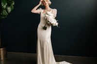 a silk A-line wedding dress with a square neckline, short puff sleeves and a train is a stylish and beautiful idea for a romantic wedding