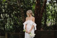 a silk off the shoulder wedding dress with bows on the arms, a train is a lovely idea for a minimalist bride