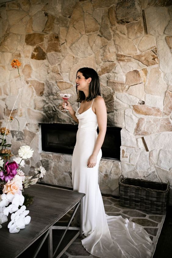 a silk slip wedding dress with a cowl neckline and a train is a sexy and stylish idea for a modern wedding