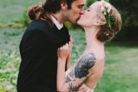 a strapless wedding dress to show off the bride’s black ink tattoo on the shoulder and arm and make it part of the look