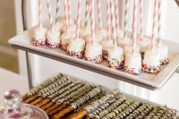 a stylish modern wedding dessert stand with marshmallow pops and cookies on rectangular plates is a lovely idea
