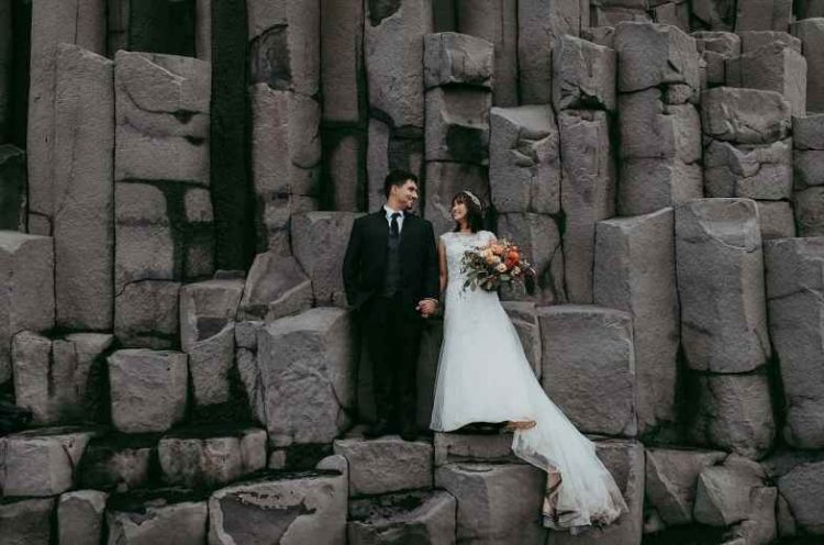 a stylish three-piece wedding suit with a grey waistcoat, a lace embellished A-line wedding dress with a train