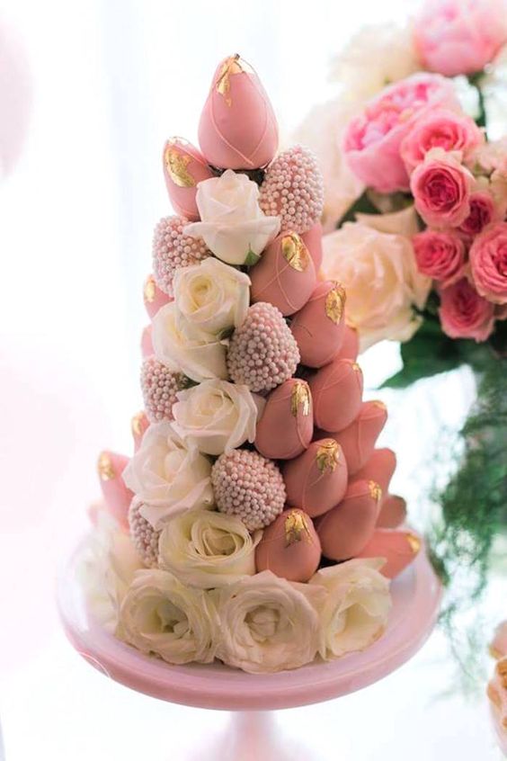 a tower of pink candied strawberries and white roses is a gorgeous idea for your bridal shower dessert table