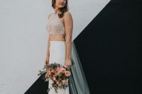 a unique bridal look with a crochet lace halter neckline crop top, a plain skirt with a train and a veil is amazing for an edgy wedding