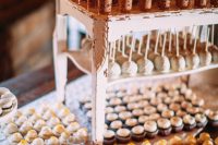 a vintage white stool used as a wedding dessert stand is a simple idea – just reuse what you already have