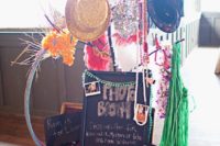 a whole photo booth prop arrangement – glitter hats, garlands, hats, glasses, chalkboard signs and more