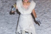 an Icelandic bride wearing a floral wedding dress with an asymmetrical skirt, peep toe lace up boots, a faux fur shawl and grey gloves