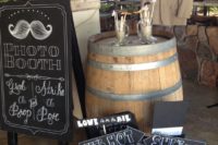 an arrangement of chalkboard props and a matching photo booth sign are great for a rustic or modern photo booth