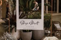 an elegant Polaroid photo booth with fresh blooms and greenery is a chic and stylish idea