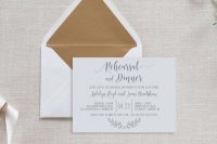 an ethereal and neutral rehearsal dinner invitation with calligraphy and an envelope with gold lining