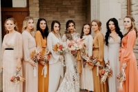 an eye-catchy mismatching bridal party with blush, off-white, orange and yellow maxi bridesmaid dresses with long sleeves