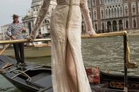 an ivory wedding dress with a plunging neckline, a front slit and illusion lace sleeves