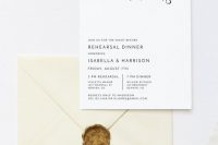 an ultra-modern and minimal rehearsal dinner invitation with calligraphy and an ivory envelope