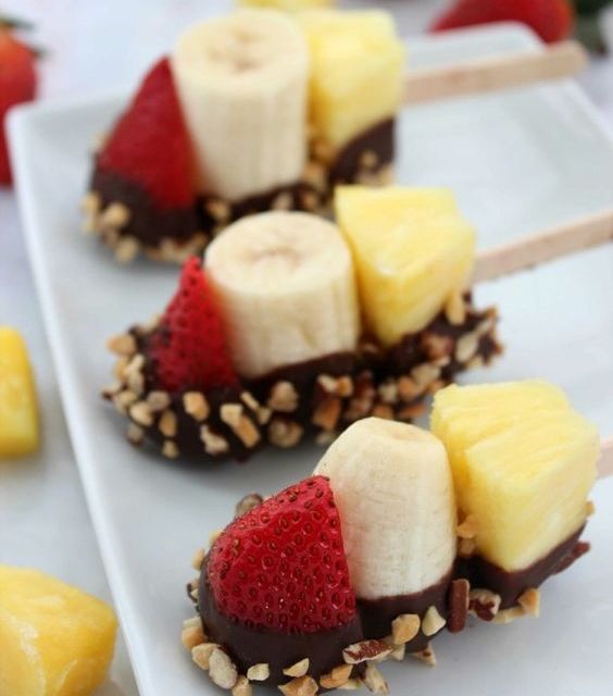 banana, pineapple, strawberry kabobs with chocolate and nuts on top are deliciously fresh