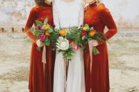 bold rust-colored velvet midi bridesmaid dresses with turtlenecks and long sleeves look statement-like and perfect for a fall wedding