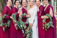 burgundy maxi bridesmaid dresses with deep V-necklines and eye-catchy long sleeves with cutouts for a bright lookat a fall wedding